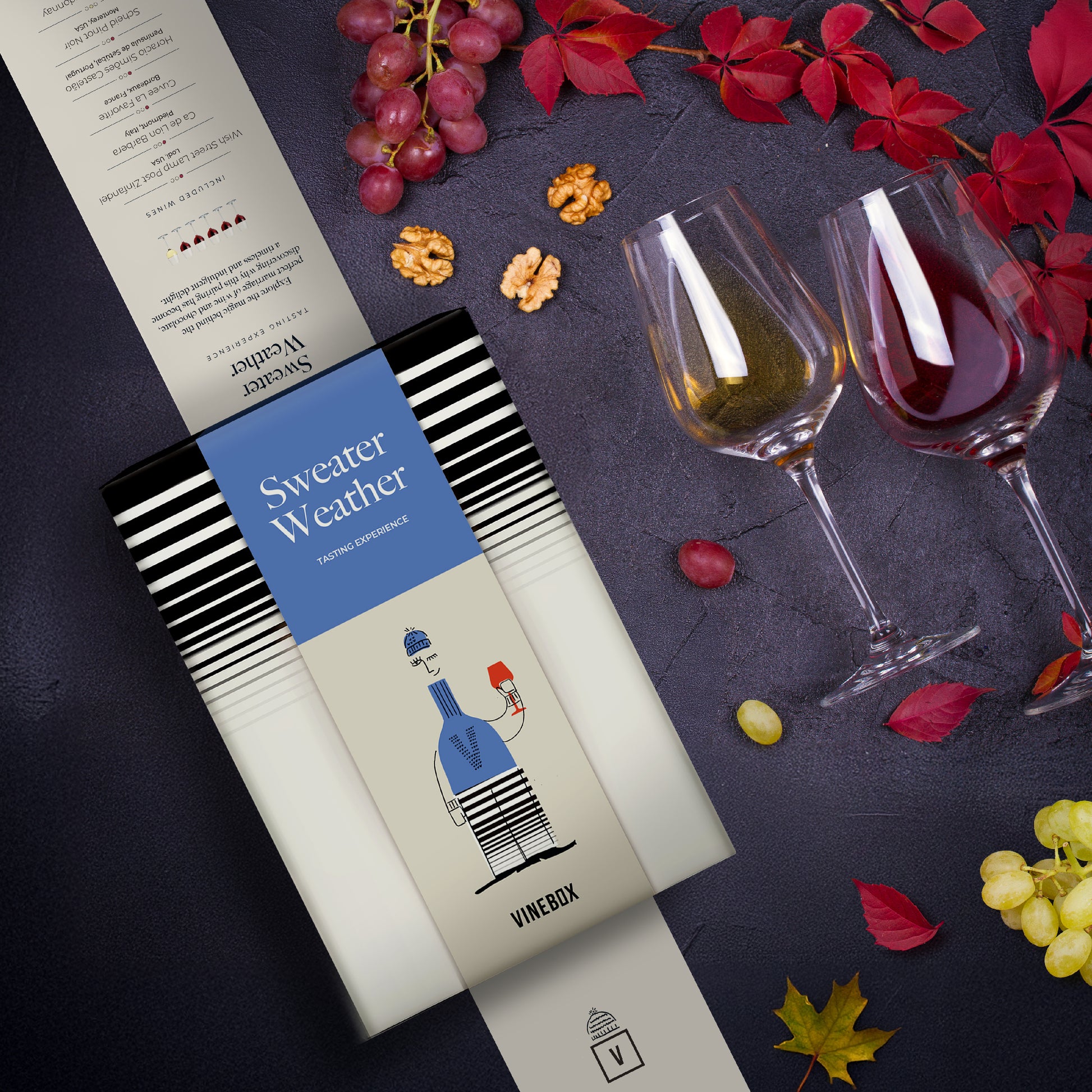 Wine box labeled 'Sweater Weather' with two wine glasses and grapes