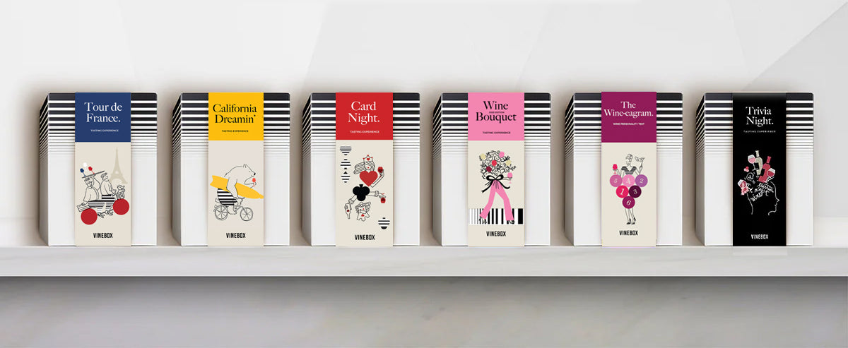 Row of books with colorful covers on a white shelf against a white wall