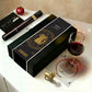 Vinebox Zodiac Tasting wine collection matched to your astrological sign. Wine box with a glass of red wine, decorative ornament, and small figurine on a white surface.