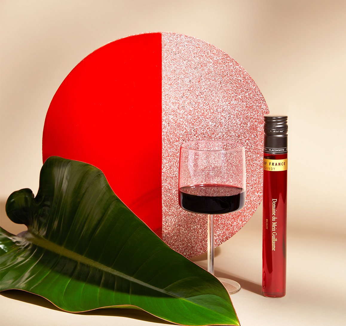 100ml tube of Vinebox wine and glass of wine with artistic background